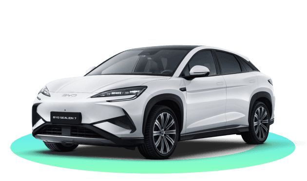 A BYD Sealion 7 electric SUV on a green platform